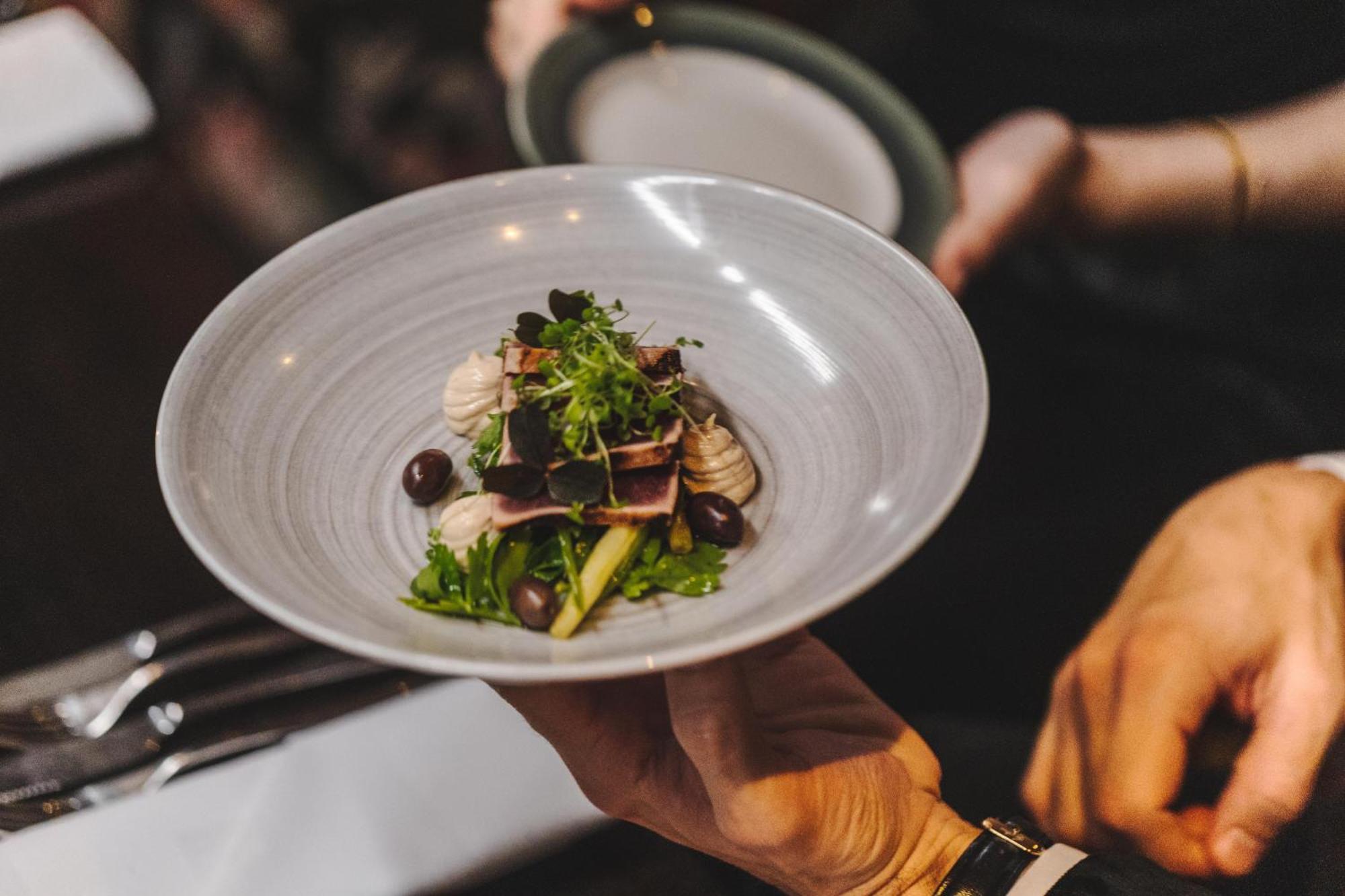 Hotel Pigalle Гётеборг Экстерьер фото A server holding a plate of food